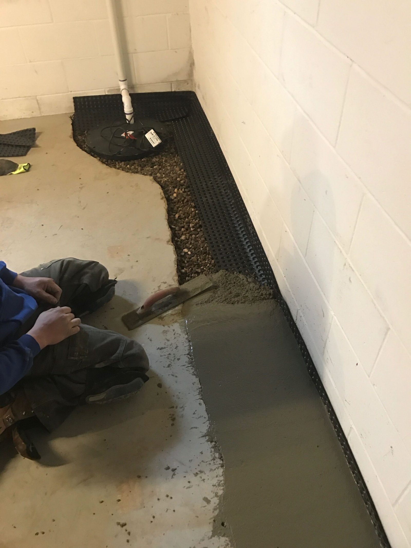 sump pump service being executed by a professional of Top Couse Masonry