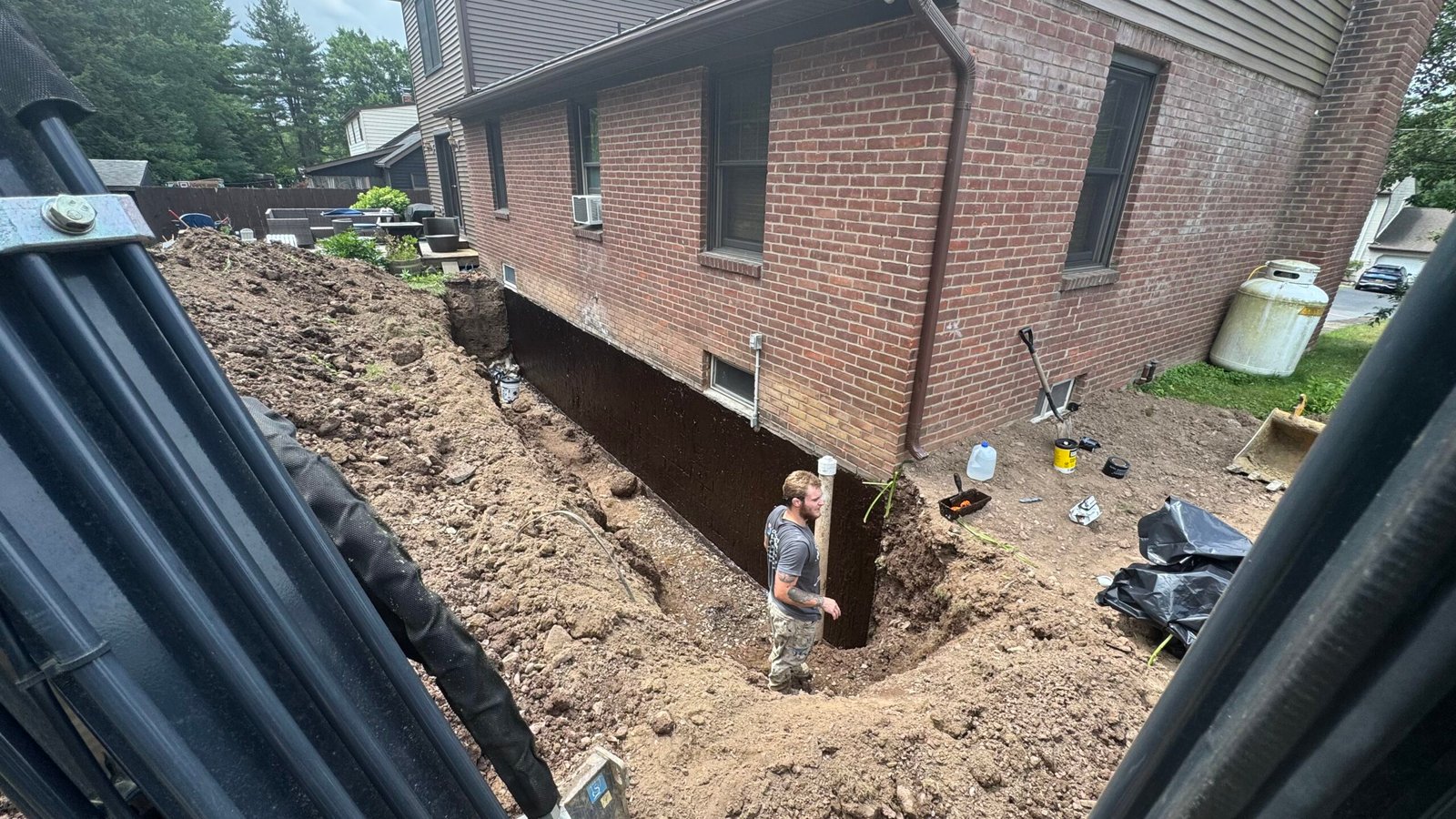 Basement waterproofing experts from Top Course Masonry finishing a service