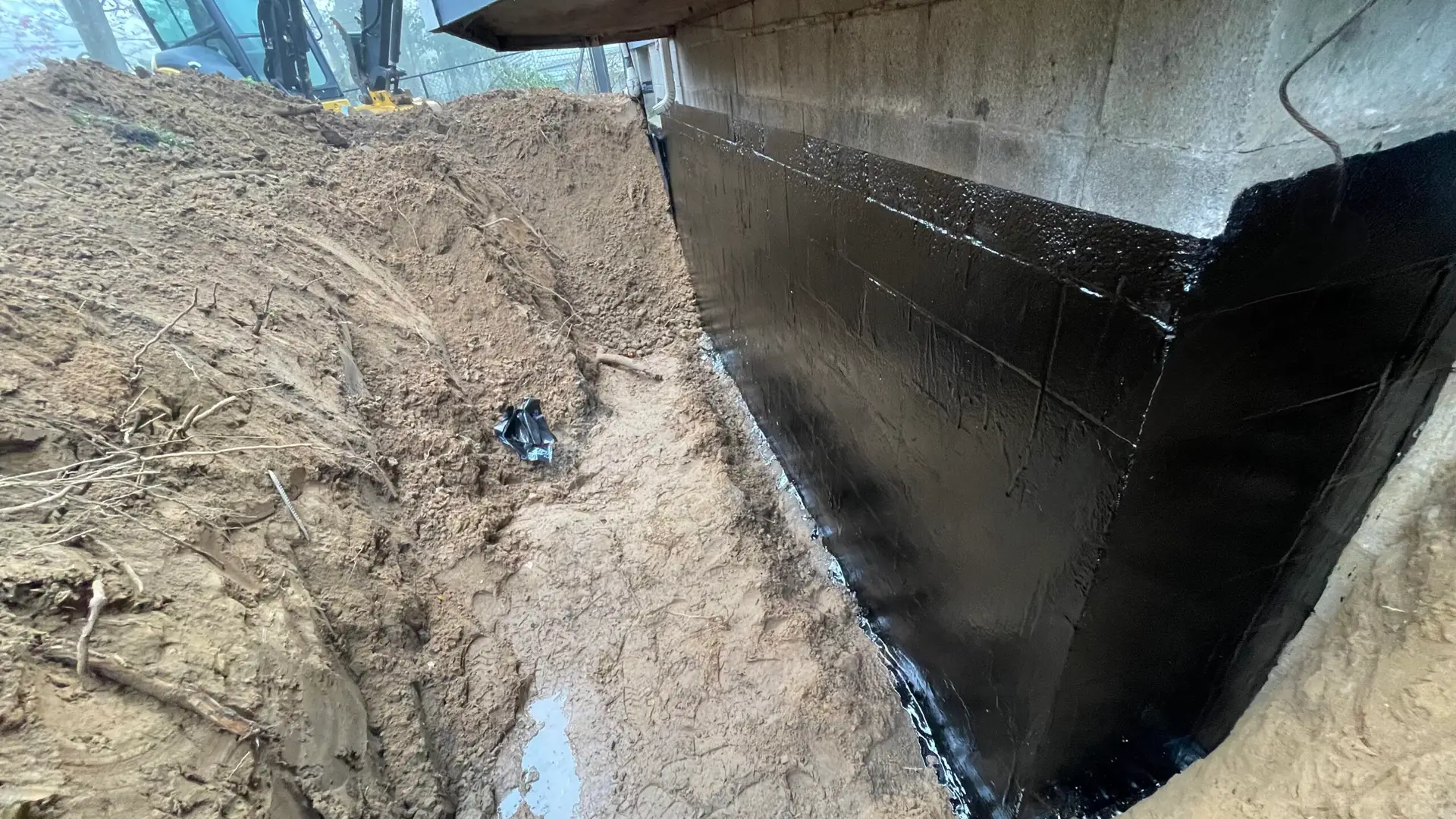 Final inspection after a basement waterproofing service by Top Course Masonry