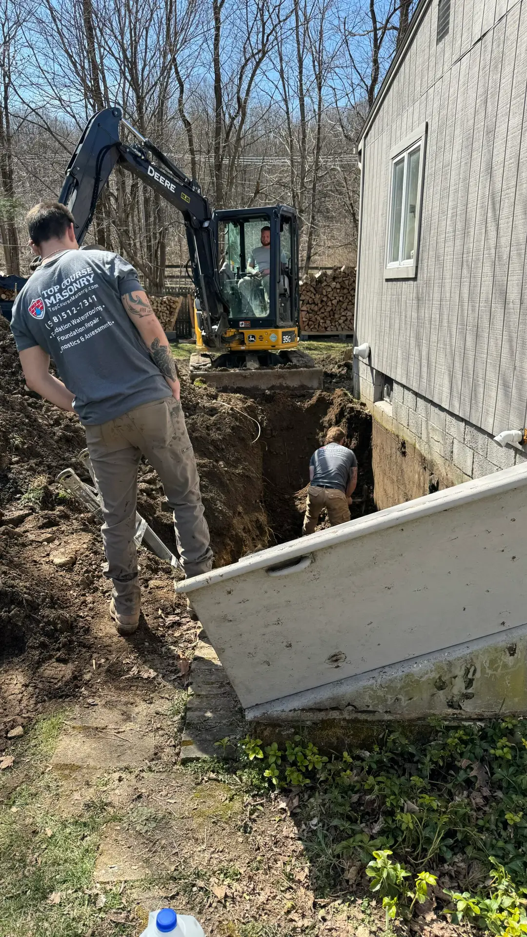 Top Course Masonry experts working on a basement waterproofing service