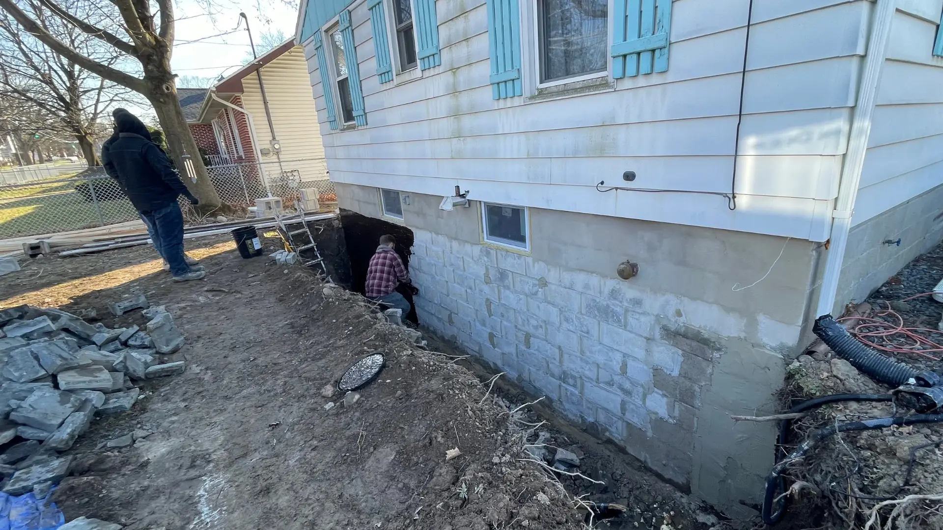 Experts from Top Course Masonry working on a basement waterproofing project.